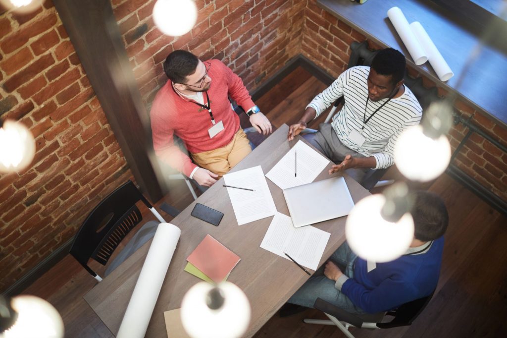 Overhead shot of people sitting at meeting during a dicsussion