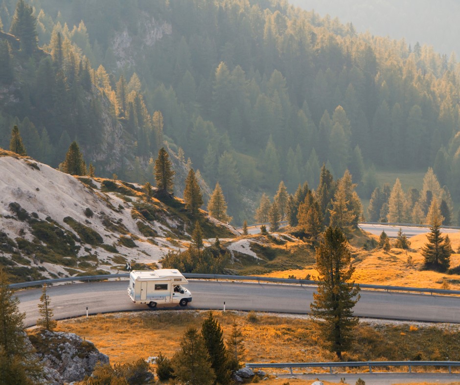 An RV driving through the mountrains | Featured image for Goals Based Investing blog from Horizon Wealth Advisory.